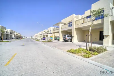 an empty street in front of a building at Exquisite 4BR Townhouse at DAMAC Hills 2, Dubailand by Deluxe Holiday Homes in Dubai