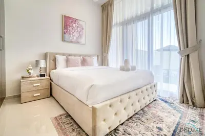 a bedroom with a large bed and a large window at Exquisite 4BR Townhouse at DAMAC Hills 2, Dubailand by Deluxe Holiday Homes in Dubai