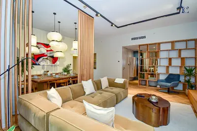 a living room with a couch and a table at Luxury Escapes - Charming 3BR plus maids Apt near JBR Beach - Sadaf 1 in Dubai