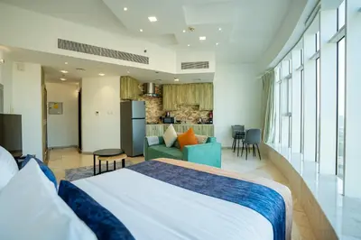 a bedroom with a bed and a living room at CitiHome - Prime Stylish Studio in Sports City in Dubai