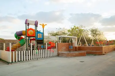 a playground with a slide and a play structure at CitiHome - Prime Stylish Studio in Sports City in Dubai