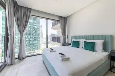 a bedroom with a large bed with a large window at Ahad Residences Studio- 15mins walk to Dubai Mall in Dubai