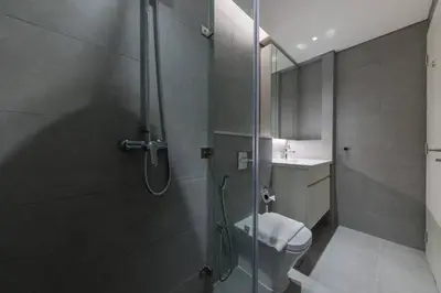 a bathroom with a shower with a toilet and a sink at Ahad Residences Studio- 15mins walk to Dubai Mall in Dubai
