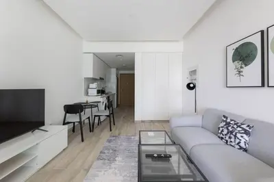 a living room with a couch and a table at Ahad Residences Studio- 15mins walk to Dubai Mall in Dubai