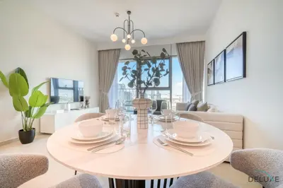 a dining room with a white table and chairs at Exquisite 1BR at Downtown Views II Tower 2 Downtown Dubai by Deluxe Holiday Homes in Dubai
