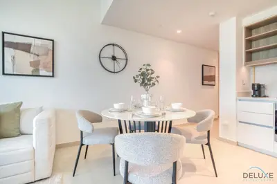 a dining room with a table and chairs at Exquisite 1BR at Downtown Views II Tower 2 Downtown Dubai by Deluxe Holiday Homes in Dubai