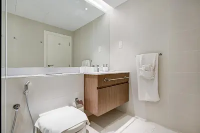 a bathroom with a toilet and a sink and a mirror at Trophy - Serene Abode near the Coast in Dubai
