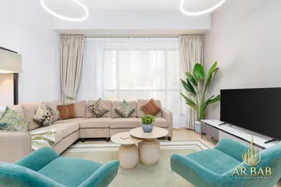 a living room with a couch and a tv at Bahar - Luxury 1BR - Near JBR Beach - Prime Location - JBR in Dubai
