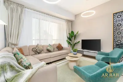 a living room with a couch and a tv at Bahar - Luxury 1BR - Near JBR Beach - Prime Location - JBR in Dubai