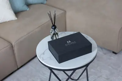 a table with a black box on top of it at Fresh & Quiet 1BR at Midtown Noor 4 Tower in Dubai