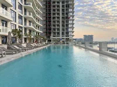 a large swimming pool in the middle of a building at 2BR Emaar Beachfront with Full Sea & Skyline Views in Dubai