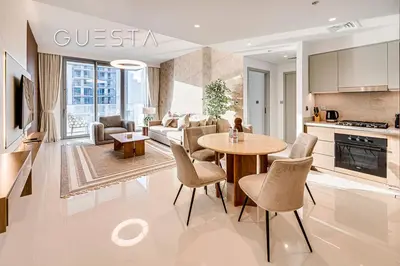 a kitchen and living room with a table and chairs at Emaar Beachfront - Beach Isle Tower 2, Dubai Marina in Dubai