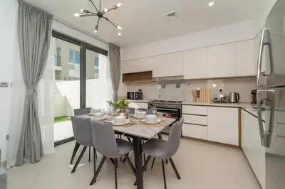 a kitchen with a table and chairs in a kitchen at Luxurious 3 BR with Maid Room in Arabian Ranches 2 in Dubai