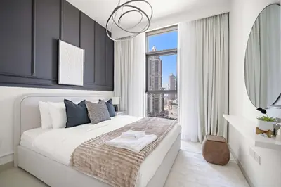 a bedroom with a large bed and a large window at Silkhaus Comfy 1BR by Burj Khalifa with Balcony in Dubai