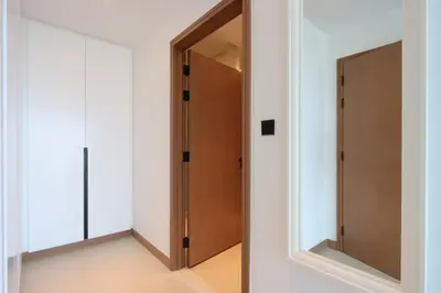 a hallway with a door and a mirror at Livbnb - Modern 3BR with Marina & Sunset View in Dubai