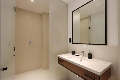 a bathroom with a sink and a mirror at Livbnb - Modern 3BR with Marina & Sunset View in Dubai