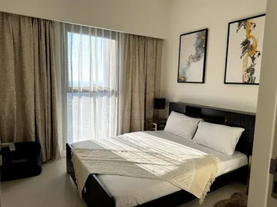 a bedroom with a large bed and a window at Burj Crown - Luxury Apartment Near Burj Khalifa in Dubai