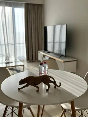 a toy monkey on top of a white table at Burj Crown - Luxury Apartment Near Burj Khalifa in Dubai