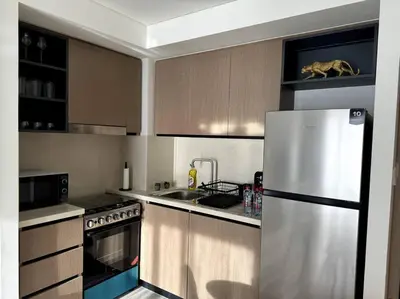 a kitchen with a stainless steel refrigerator and a sink at Burj Crown - Luxury Apartment Near Burj Khalifa in Dubai