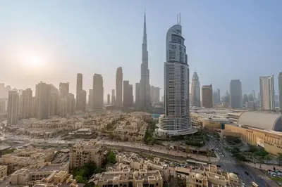 an aerial view of a city with a tall skyscraper at Maison Privee - Modern Chic Apt with Unobstructed Burj Khalifa Views in Dubai