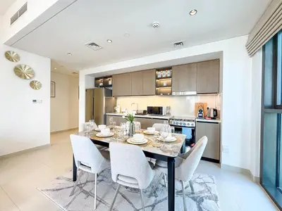 a kitchen and dining room with a table and chairs at First Class Stay in Downtown Dubai Near Burj Park by SBH in Dubai