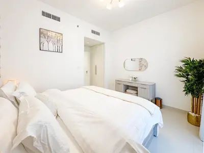 a white bedroom with a bed with white sheets at First Class Stay in Downtown Dubai Near Burj Park by SBH in Dubai