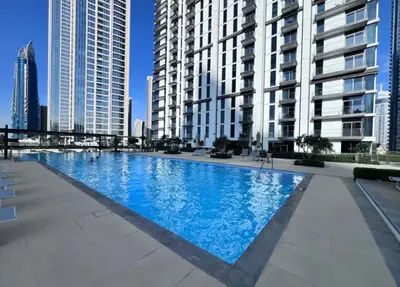 a large swimming pool in a city with tall buildings at First Class Stay in Downtown Dubai Near Burj Park by SBH in Dubai