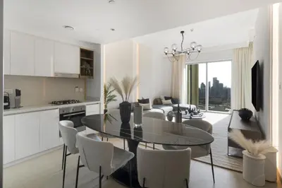 a kitchen and dining room with a table and chairs at The Smart Concierge - Downtown views 2 in Dubai