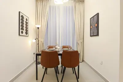 a dining room with a table and two chairs at HiGuests - Tranquil Luxury 1BR Apt in the Heart of the City in Dubai
