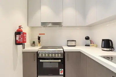 a kitchen with a stove and a counter top at HiGuests - Tranquil Luxury 1BR Apt in the Heart of the City in Dubai