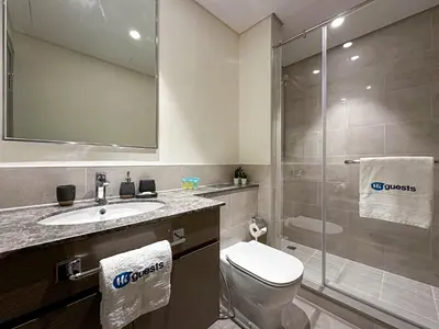 a bathroom with a toilet sink and a shower at HiGuests - Tranquil Luxury 1BR Apt in the Heart of the City in Dubai