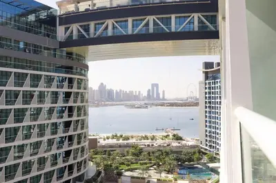 a bridge over a river between two tall buildings at Modern 1 bedroom at Palm Jumeirah in Dubai