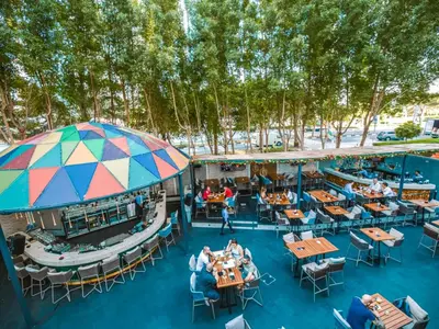 an overhead view of a pool with tables and chairs at Cosmos Living Cozy Studio GCV2 in Dubai