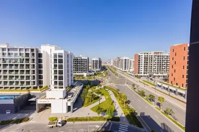 a view of a city with tall buildings and a street at Urban Charm: Luxe 1BR Haven Near Downtown Dubai in Dubai