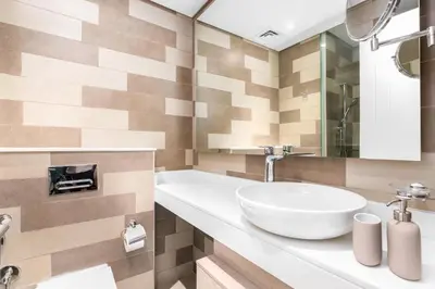 a bathroom with a white sink and a mirror at The Seven Palm in Dubai