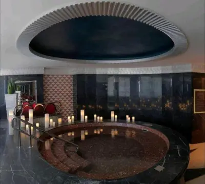 a room with a large circle with candles in it at LUX 1 bed flat with Burj Khalifa View - 3 minute walk to Dubai Mall - Best Location - Best Balcony View in Dubai