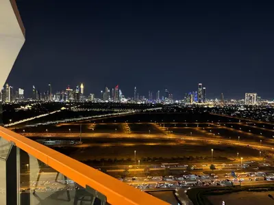 a view of a city at night with traffic at Binghatti avenue in Dubai