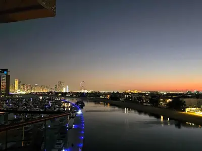 a view of a river with a city at night at Studio *stunning SEA VIEW* in Dubai