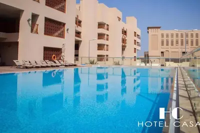 a swimming pool in front of a building at Studio *stunning SEA VIEW* in Dubai