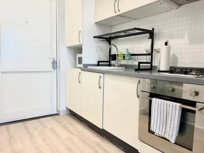a kitchen with white cabinets and stainless steel appliances at Studio *stunning SEA VIEW* in Dubai