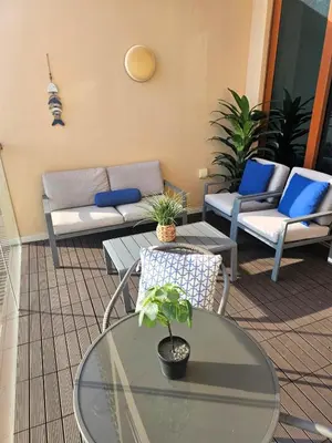 a patio with a couch and a table and chairs at Studio *stunning SEA VIEW* in Dubai