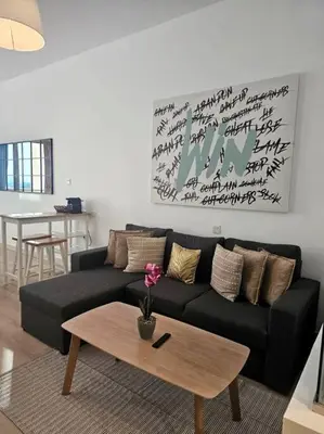 a living room with a black couch and a coffee table at Studio *stunning SEA VIEW* in Dubai