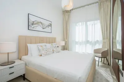 a white bedroom with a large bed and a window at Homesgetaway Luxury 2BR at Socio Dubai hills in Dubai