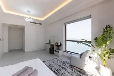 a large white room with a large window and a couch at Stylish 3bdr apartment in Rimal 2 JBR in Dubai
