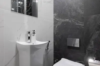 a black and white bathroom with a toilet and a sink at Stylish 3bdr apartment in Rimal 2 JBR in Dubai