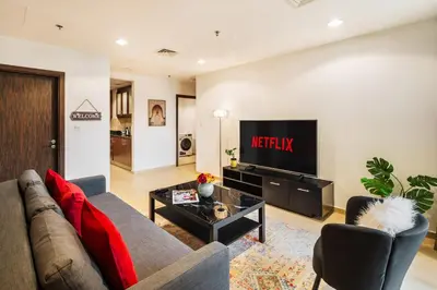 a living room with a couch and a tv at Spacious, Deluxe, 5BR plus maidroom on JBR walk Next to Beach ,Tram & Mall by La Buena Vida Holiday Homes in Dubai