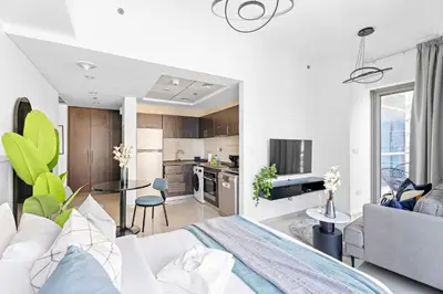 a living room and kitchen with a bed and a couch at Silkhaus Studio at Dubai Marina Near Marina Mall in Dubai