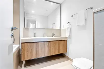 a bathroom with a sink and a mirror at Silkhaus Elite 2BDR with View with Pool & Gym in Dubai