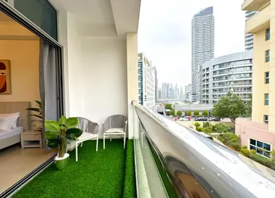 a balcony in a building with green grass at WOW Studio w/ Balcony and Canal View in Marina in Dubai
