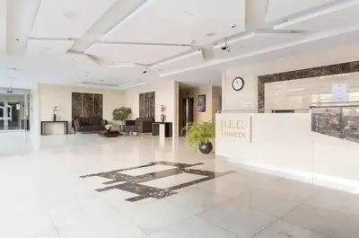 a lobby of a building with a clock on the wall at WOW Studio w/ Balcony and Canal View in Marina in Dubai